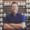 A man stands before shelves filled with various pill bottles