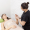 A woman lies on a treatment table covered with a towel